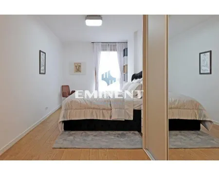 Furnished bedroom with a double bed, wooden flooring, and a large mirrored wardrobe. - image 8