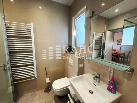 Modernly equipped bathroom with sanitary facilities and a shower cabin. - image 11