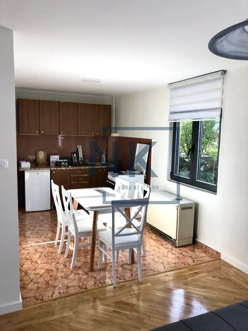 Kitchen with a dining area and wooden cabinetry.