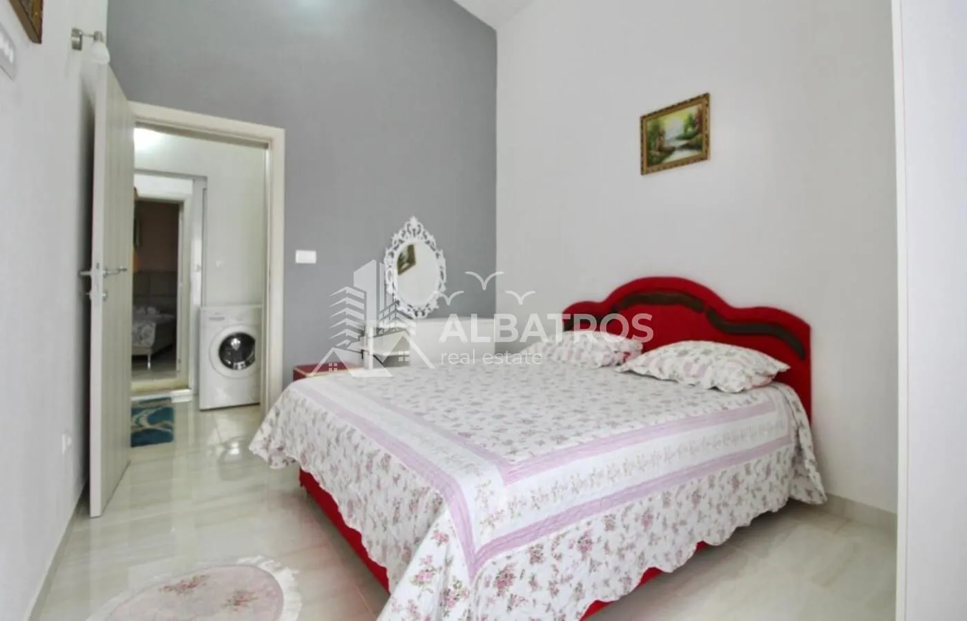 Furnished bedroom with a double bed and a view of the hallway.