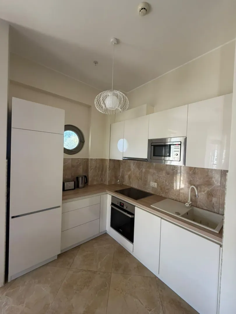 Modern white kitchen with built-in appliances.