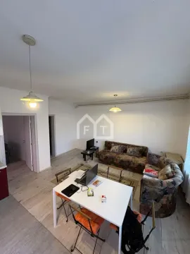 Living room with a sofa set, dining table, and work area. - image 3
