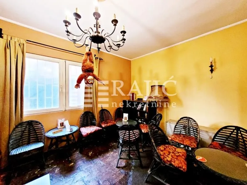 Living room with seating furniture and a chandelier.