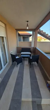 Covered terrace with seating furniture. - image 9