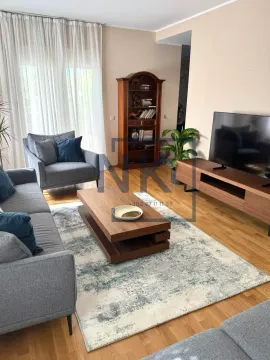 Living room with sofa, television, and wooden furniture. - image 2