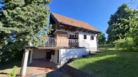 Exterior of the house with a yard and a covered area on the ground floor. - image 4