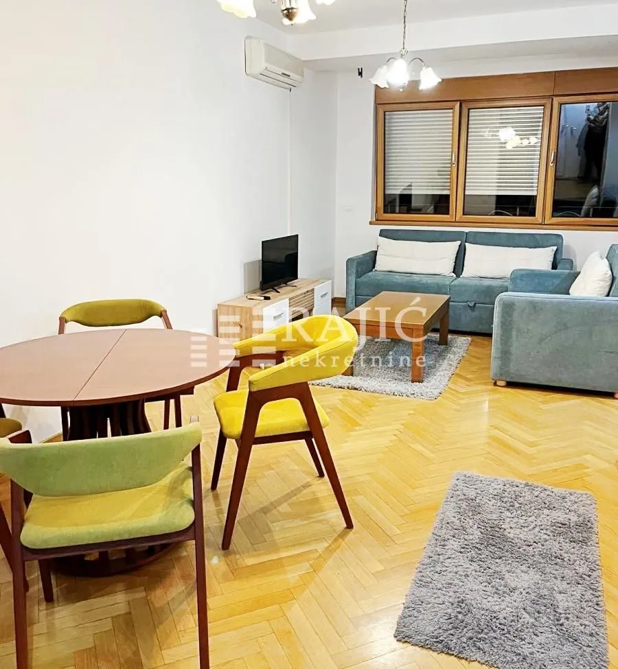 Living room with a sofa set and dining table.