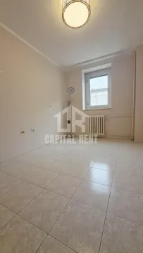 Empty room with tiled flooring, a window, and a radiator. - image 9