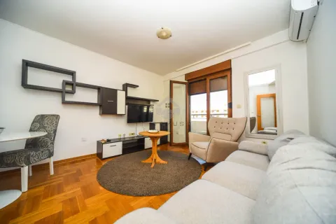 Living room with a sofa set, TV, dining table and access to the terrace. - image 2