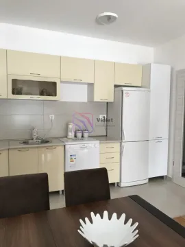 Kitchen with cream-colored units and white appliances. - image 9
