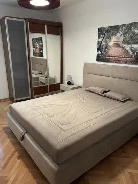 Bright bedroom with a large double bed and a wardrobe. - image 8