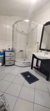 Bathroom with a shower cabin, sink, and mirror. - image 14
