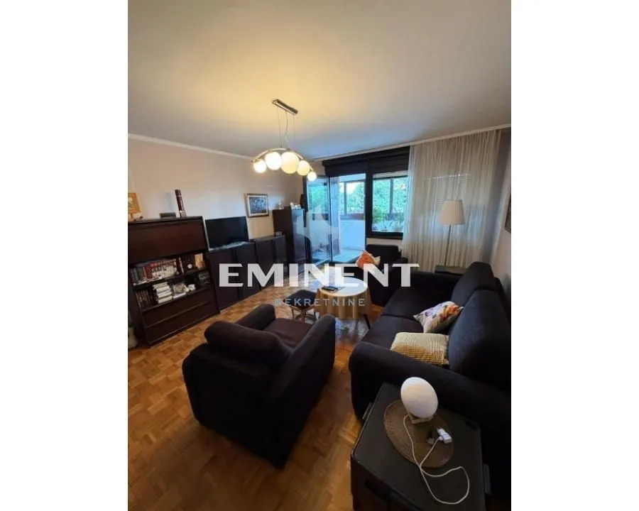Living room with sofa set, TV and access to the terrace.