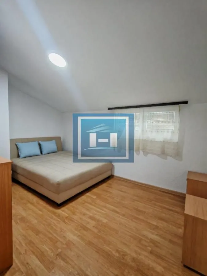 Bedroom with a double bed and wooden flooring.