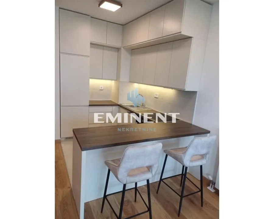 Modern kitchen with a bar counter and bar stools.