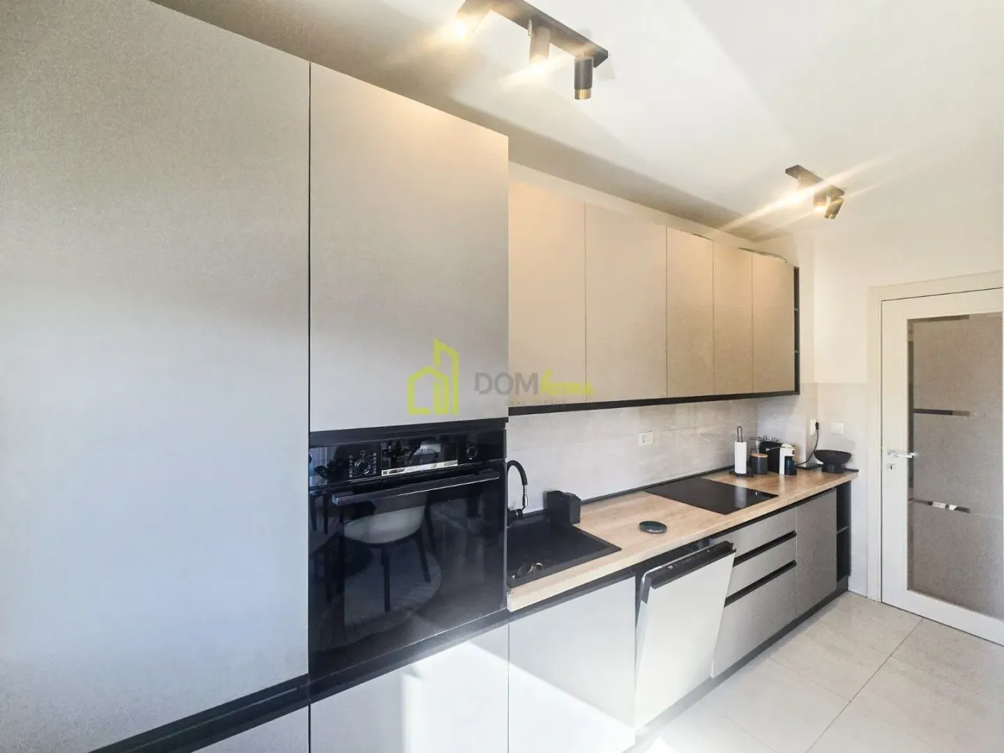 Modern kitchen with built-in cabinetry and appliances.