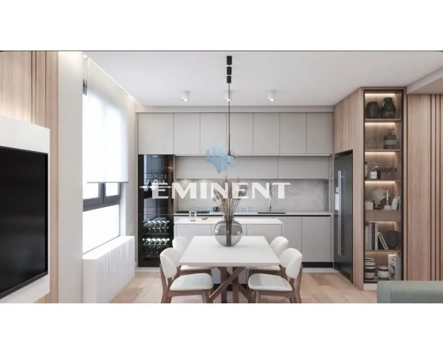 Modern kitchen with dining area and built-in appliances.