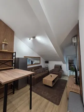 Living room with sofa, dining table and slanted ceilings. - image 17