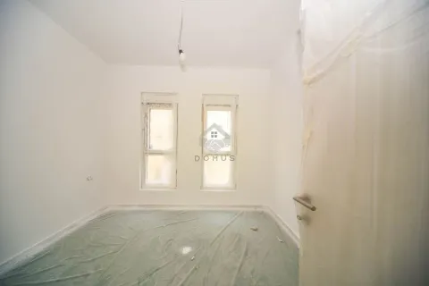 Empty unfinished room with white walls and two windows. - image 12