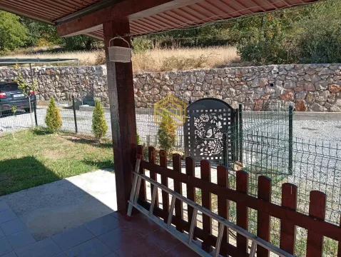 View from the covered terrace towards the fenced yard and gate. - image 2