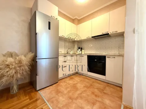 Small kitchen with light cabinets and built-in appliances. - image 5