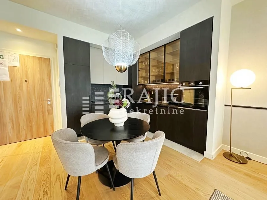 Modern kitchen with a dining table and chairs.