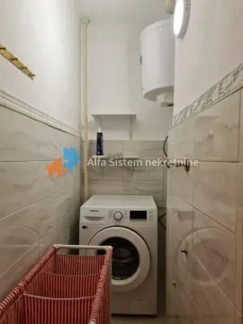 Smaller bathroom with a washing machine and water heater. - image 23