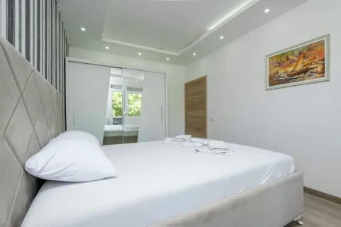 Bright bedroom with a double bed, white wardrobe and recessed lighting. - image 6