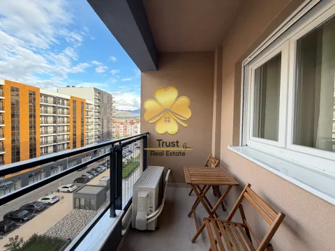 Furnished balcony with seating set and city view. - image 7