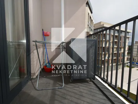Balcony with a clothes drying rack and an air conditioner unit. - image 10