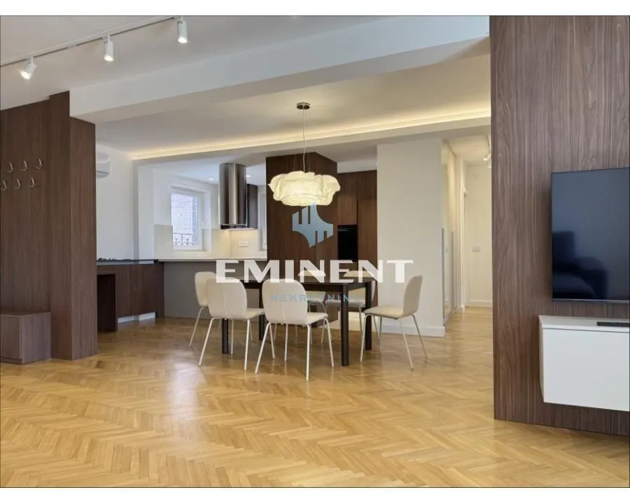Living room with dining area and parquet flooring.