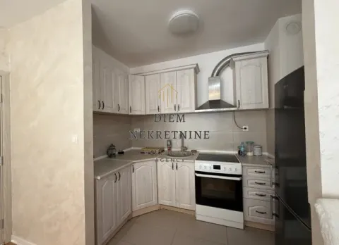 Kitchen equipped with light wooden cabinets and white appliances. - image 8
