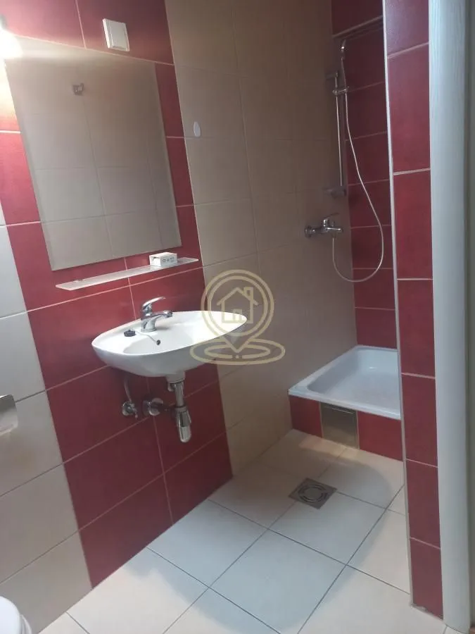 Small bathroom with a shower cabin, washbasin, and mirror.