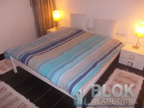 Furnished bedroom with a double bed and nightstands. - image 4