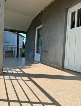 Covered terrace with tiled flooring and an entrance to the building. - image 7