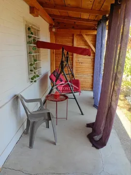 Covered terrace with a swing and a table. - image 18