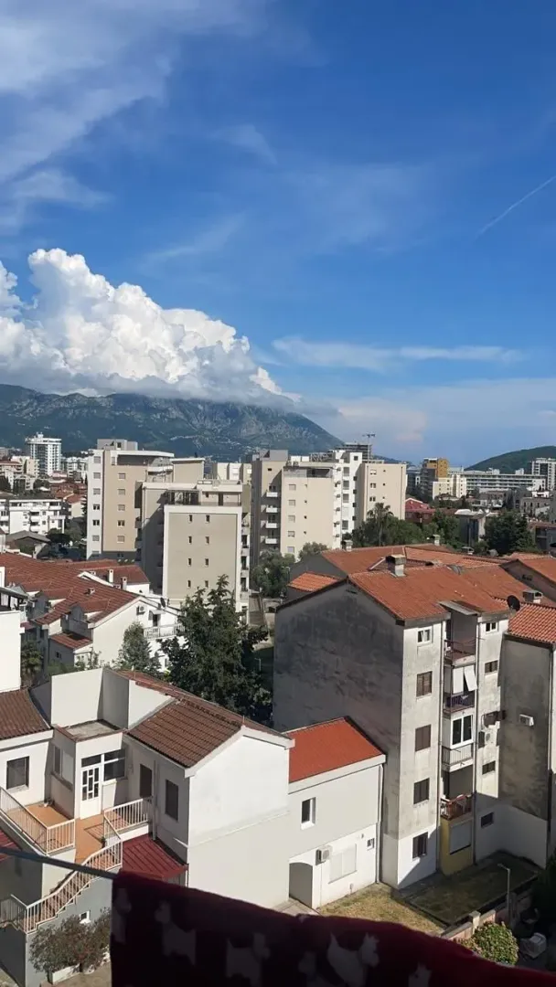 View from the terrace overlooking the urban area and mountains in the background.