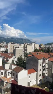 View from the terrace overlooking the urban area and mountains in the background. - image 3