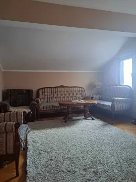 Dnevna soba sa garniturom za sedenje i drvenim stočićem. - image 3