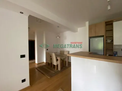 View of the kitchen with a breakfast bar and the dining area beyond. - image 8