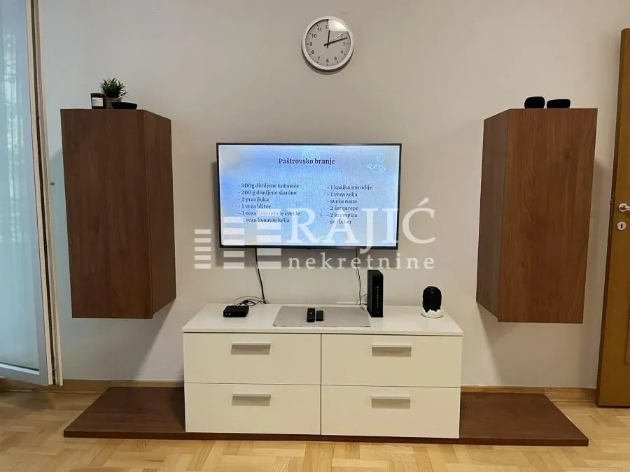 Living room with a TV cabinet and wall units.
