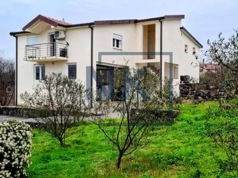 View of the yard and the facade of the house with a balcony and greenery. - image 7