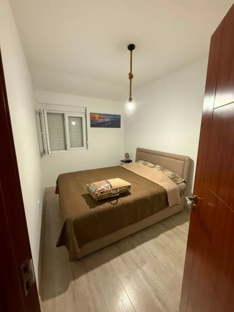 Small bedroom with a double bed and a window.