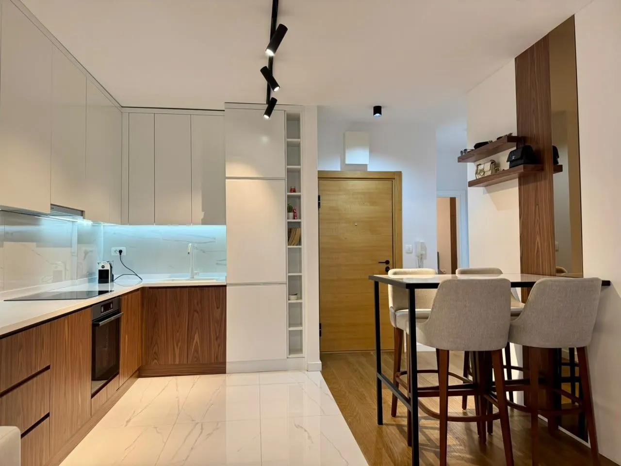 Modern kitchen with a dining table and chairs in an open space.