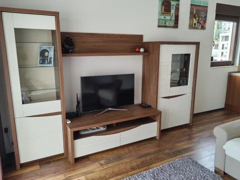 Living room with a TV unit and wooden flooring. - image 6