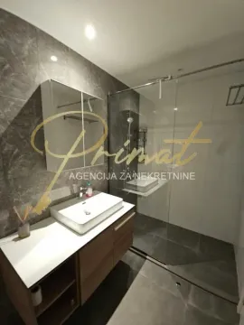 Modernly equipped bathroom with a washbasin and a walk-in shower. - image 7