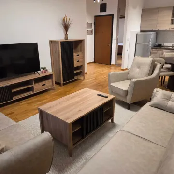 Living room with sofa set, TV and a view of the kitchen. - image 2