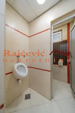 View of the bathroom with a urinal and wall tiles. - image 17
