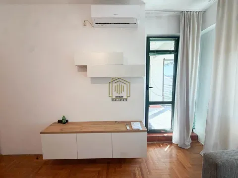Dnevna soba sa drvenim podom, bijelim komadom namještaja i izlazom na terasu. - image 11
