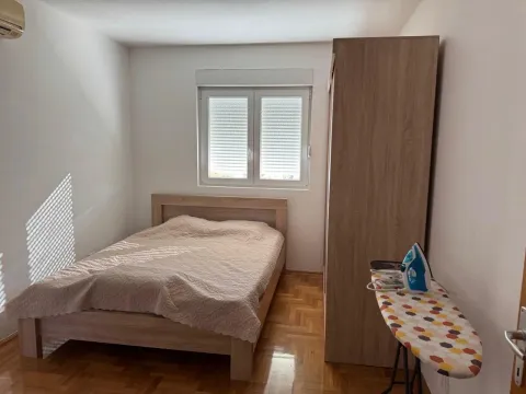 Furnished bedroom with a double bed, wardrobe, and window. - image 9